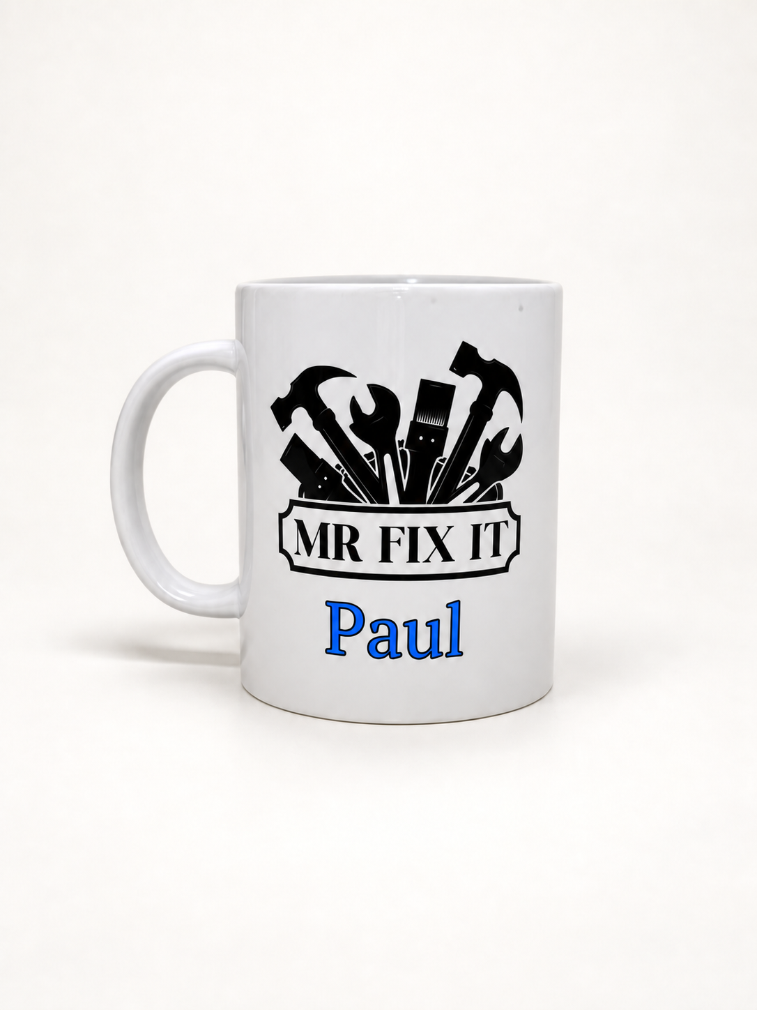 Personalized white 12 oz coffee mug with Mr Fix It design and bright blue name